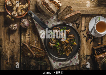 Poêlée de champignons frais avec les herbes, l'ail grillé, de pain maison Banque D'Images