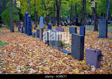 Sur les pierres tombales du cimetière de l'automne. Les feuilles colorées sur le sol. Banque D'Images