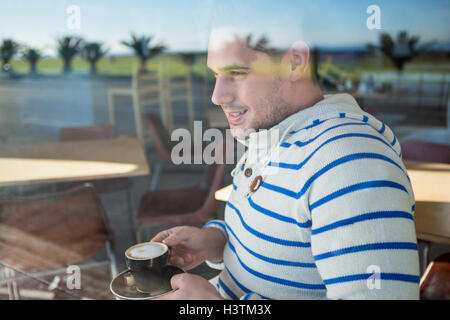A Smiling man holding Coffee cup Banque D'Images