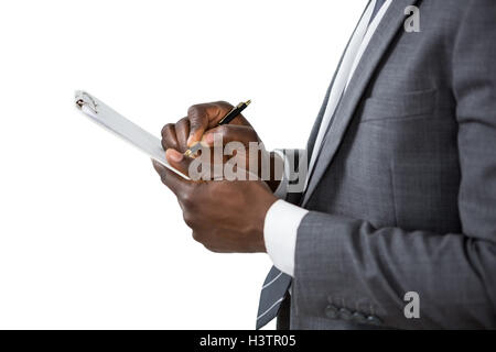 Businessman writing on clipboard Banque D'Images