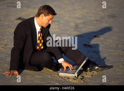 Plage de sable fin, de l'homme d'affaires, ordinateur portable, plage d'entrée de données, l'homme d'action, poursuite, gestionnaire, s'asseoir, sable, ordinateur portable, ordinateur portable, sans fil, de données, de l'information, demande de la navigation sur Internet, Internet, mobilité, flexibilité, d'accessibilité, d'abandon, 'bourreau de vacatio', Banque D'Images