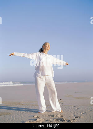 Plage de sable fin, femme, Taïchi, meilleur âge, de 50 à 60 ans, la plage, la mer, les loisirs, hobby, pratique, méditative, motion, motion, séquences, exercices, lentement, couramment, les haut-parleurs de l'ombre, "libre circulation circulation', l'équilibre, l'activité, conscience du corps, la méditation, le Tai Banque D'Images