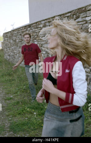 Meadow, muraille, femme, exécuter, trace l'homme, détail, couple, de 20 à 30 ans, poursuite, courir après, menacer, la peur, la menace, fuir, fuir, regarde autour de moi, l'activité criminelle, la peine, la nuisance, la quête illusoire, lutte, de conflit, de mouvement, de l'extérieur, fas Banque D'Images