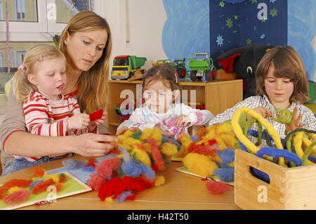 La maternelle, éducateur, les enfants, bricoler, conte de la laine, d'avis de chaînes, de personnes, les enfants de maternelle, enfants, trois, fille, garçon, femme, enseignante de maternelle, puéricultrice, la laine, le feutre de laine, Fantasia, créativité, cordes, jouer, sélectionnez des couleurs vives, dans Banque D'Images