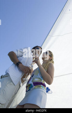 Sail yacht, couple, prêt, vin mousseux, boire, les gens, les amoureux, le socle, le kick off deck, cap solaire, verres de champagne, verres de champagne, champagnes, profiter, amour, affection, départs, voile voyage, loisirs, vacances, luxe, Summers, repos, vie, Banque D'Images