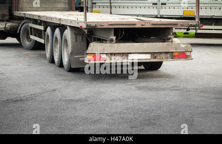 Feu arrière arrière avec fragment de camion vide cargo remorque sur route asphaltée. Banque D'Images