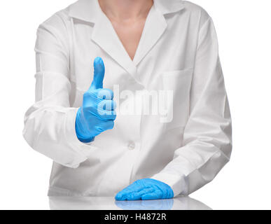 Close up of female doctor en blanc et bleu robe médical gants chirurgicaux stérilisés showing Thumbs up sign Banque D'Images