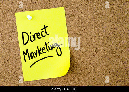 Marketing direct texte écrit sur du papier jaune note épinglée sur le panneau de liège avec punaise blanche. L'image du concept d'entreprise Banque D'Images