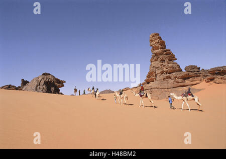 La Libye, le Djebel Akakus, randonnée désert, chameau, au nord, d'Afrique, paysages sauvages, désert, sable, roche, la bile formations, animaux, mammifères, bénéficier d'animaux, bêtes, fardeau, touristes, gens du chameau, d'attraction, de l'expérience, l'aventure, vacances, loisirs, safari, le tourisme, l'icône, la solitude, l'isolement, sortie, sécheresse, sécheresse, pénurie d'eau, de la vie sauvage, le tourisme, hostilely Banque D'Images