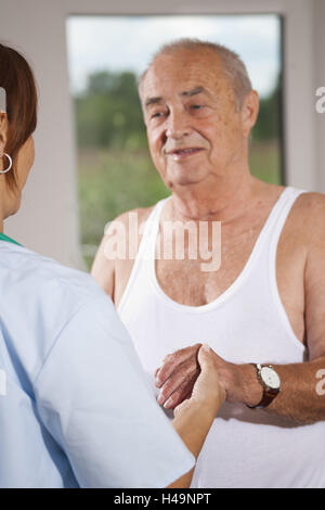 Nurse holding les mains d'un senior, Banque D'Images