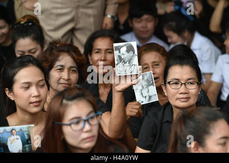 Bangkok, Thaïlande. 14Th Oct, 2016. Les thaïs tenir photos le Roi Bhumibol Adulyadej de Thaïlande près du Grand Palais à Bangkok, Thaïlande, le 14 octobre, 2016. Le reste de la Thaïlande le Roi Bhumibol Adulyadej, qui est décédé jeudi à l'hôpital Siriraj, ont été transférés de l'hôpital au Grand Palais le vendredi avec les Thaïlandais en deuil en le voyant éteint. Mangmang Crédit : Li/Xinhua/Alamy Live News Banque D'Images