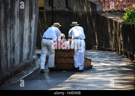 Les touristes voyageant en bas du panier de luge en osier tour de panier, Monte, Madère Banque D'Images