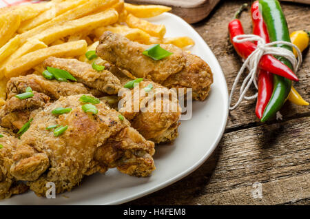 Poulet frit, frites et de chili trempette et oignons de printemps sur le dessus du repas Banque D'Images