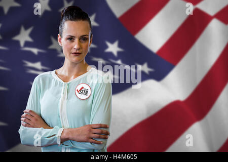 Composite image of Beautiful woman standing with arms crossed Banque D'Images