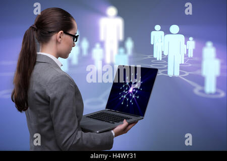 Businesswoman with laptop in social network concept Banque D'Images