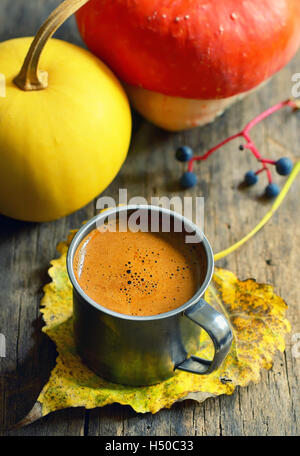 Tasse de café sur la feuille d'automne sur le fond en bois Banque D'Images