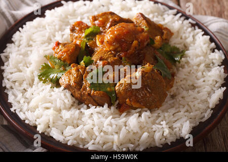 La cuisine indienne : boeuf madras avec du riz basmati close-up sur une plaque horizontale. Banque D'Images