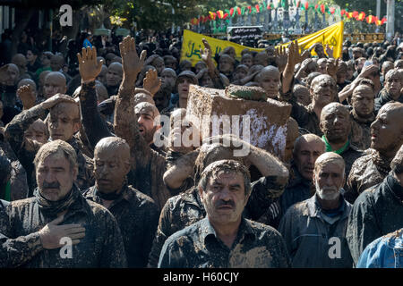 10 Muharram (Ashura), Bijar, des hommes couverts de boue transportant le cercueil de l'Imam Hussain Procession pendant Banque D'Images