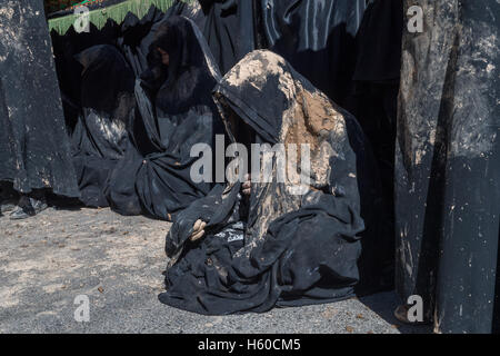 10 Muharram (Ashura), Bijar, deuil Femmes portant tchador couvert de boue Banque D'Images