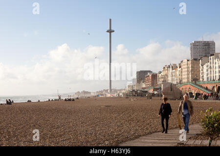 Les gens qui marchent sur la promenade de Brighton, avec l'i360 tour d'observation à l'arrière-plan, Brighton, East Sussex, UK Banque D'Images