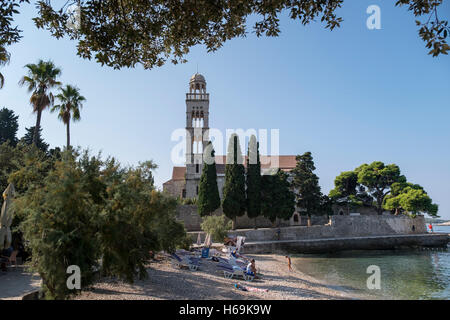 Se détendre sur une plage par une anse de la mer Adriatique à proximité du monastère franciscain de la ville de Hvar sur l'île de Hvar en Croa Banque D'Images