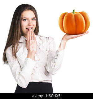 Surpris woman holding pumpkin. Banque D'Images