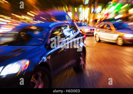 Photo avec l'appareil photo fait effet de zoom d'une scène de la circulation dans la ville la nuit Banque D'Images
