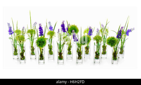 Bouquets de fleurs artificielles dans des vases de verre centre arrangement sur fond blanc. Banque D'Images