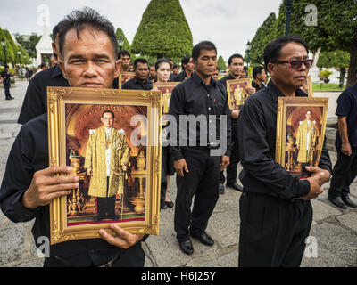 Bangkok, Thaïlande. 29 Oct, 2016. Les hommes détiennent des photos de la fin, le Roi Bhumibol Adulyadej de Thaïlande, alors qu'ils entrent dans le Grand Palais pour rendre hommage au Roi. Samedi était le premier jour de Thaïlandais pourrait rendre hommage à la fin de l'urne funéraire Bhumibol Adulyadej, Roi de Thaïlande, au Dusit Maha Prasart dans la salle du trône du Grand Palais. Credit : ZUMA Press, Inc./Alamy Live News Banque D'Images