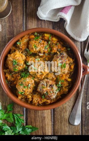 Boulettes de porc et de pomme dans un plat de céramique Banque D'Images