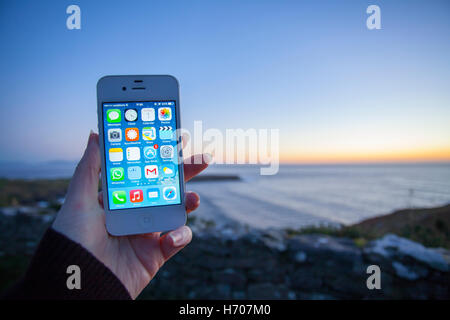Mains à l'aide d'un téléphone intelligent de prendre une photographie d'un paysage au crépuscule Banque D'Images