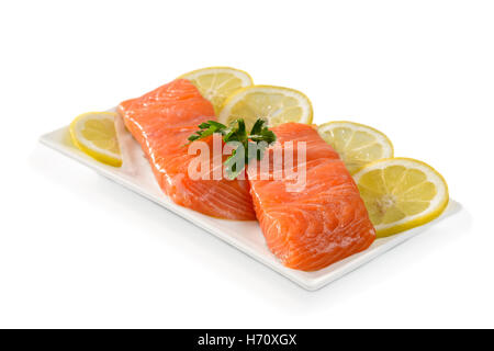 Les filets de saumon avec des tranches de citron sur un fond blanc Banque D'Images