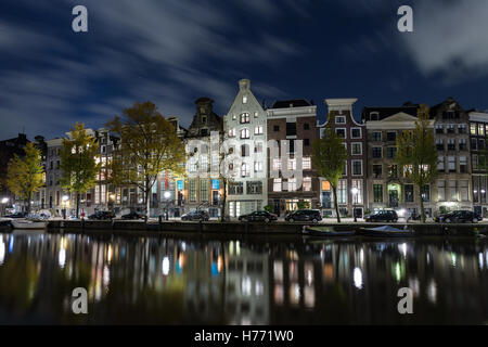 Maisons à Amsterdam, Pays-Bas la nuit reflétée dans le canal Banque D'Images