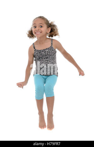 Jeune fille active Jumping With Joy isolé sur fond blanc Banque D'Images