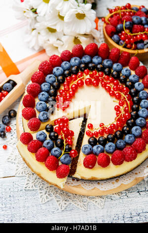 Gâteau au fromage et bleuets framboises sur table en bois Banque D'Images