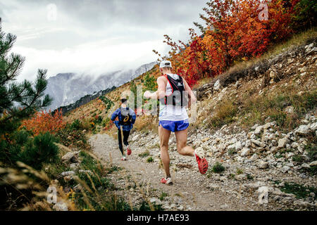 Les coureurs deux athlètes de montagne le long trail en paysage d'automne au cours de Crimée marathon de montagne Banque D'Images