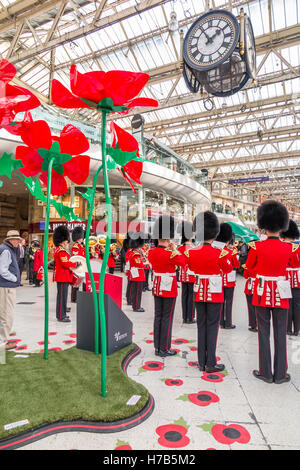 La gare de Waterloo, Londres, Royaume-Uni. 3 novembre, 2016. La bande de les Grenadier Guards effectue pour les navetteurs et les passagers dans le grand hall de la gare de Waterloo, Londres, Royaume-Uni. Leur performance a été à l'appui de la Royal British Legion Poppy Appel. Credit : Graham Prentice/Alamy Live News Banque D'Images