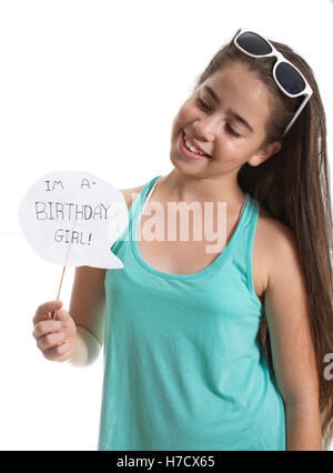 Smiling adolescent girl with sunglasses holding an Je suis une fille d'anniversaire sign - isolated on white Banque D'Images