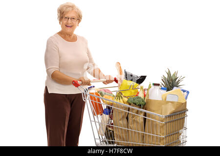 Cheerful mature dame avec un panier plein de provisions isolé sur fond blanc Banque D'Images