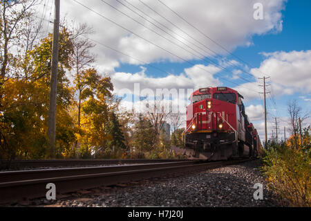 Photo de train de fret avec des couleurs d'automne et ciel bleu. Banque D'Images