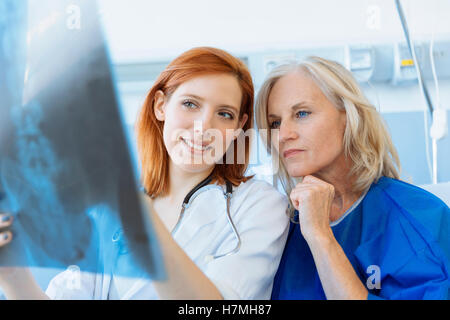 Doctor showing xray pour un senior patient in hospital Banque D'Images