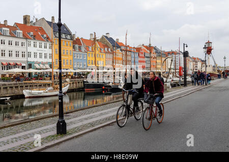 Les cyclistes le long du canal de Nyhavn à Copenhague, Danemark Banque D'Images