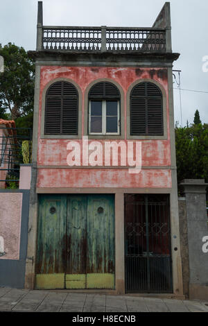 Bâtiment abandonné près de la rue, bâtiment avec la décoloration de la peinture sur elle, l'ancien bâtiment de la ville de Funchal. Banque D'Images