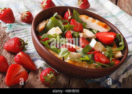 Salade fraîche avec fraise, poulet, brie et roquette close-up sur la table horizontale. Banque D'Images