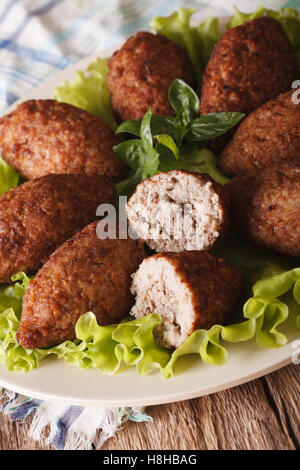 Kubbeh épicée délicieuse avec le boulgour, l'oignon et les noix de pin sur une plaque macro. La verticale Banque D'Images