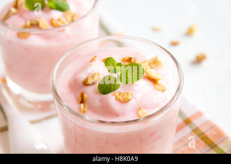 Rose bio faits maison granola avec yogourt aux fraises et menthe en lunettes partie close up Banque D'Images