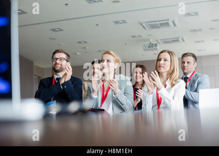 Confident business people applaudir au cours de séminaire Banque D'Images