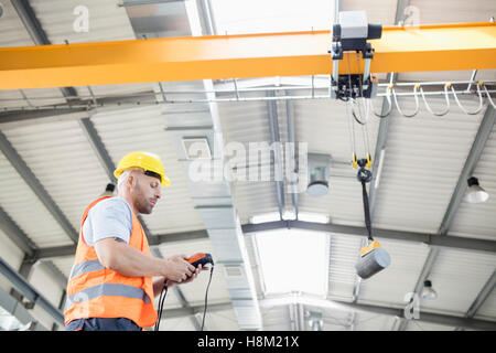 Low angle view of travailleur manuel grue Levage d'exploitation dans l'industrie de l'acier Banque D'Images