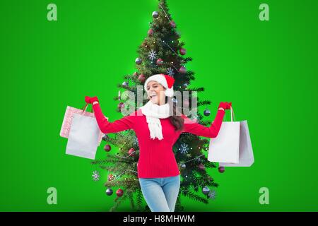 Woman holding shopping bags near Christmas Tree Banque D'Images