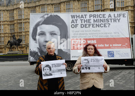 Christine Quinn (à gauche) et Roberta O'Neil, les filles de Christopher Quinn, en face d'une affiche à Westminster, Londres mettant en lumière la façon dont ils ont été traités à la suite de l'assassinat de leurs proches par des soldats britanniques. Banque D'Images